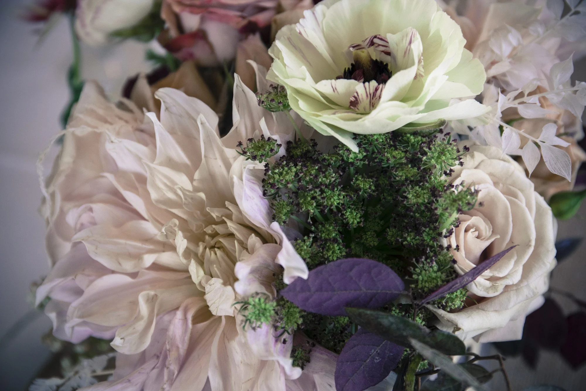 Bridal bouquet resting against layers of wedding fabric.