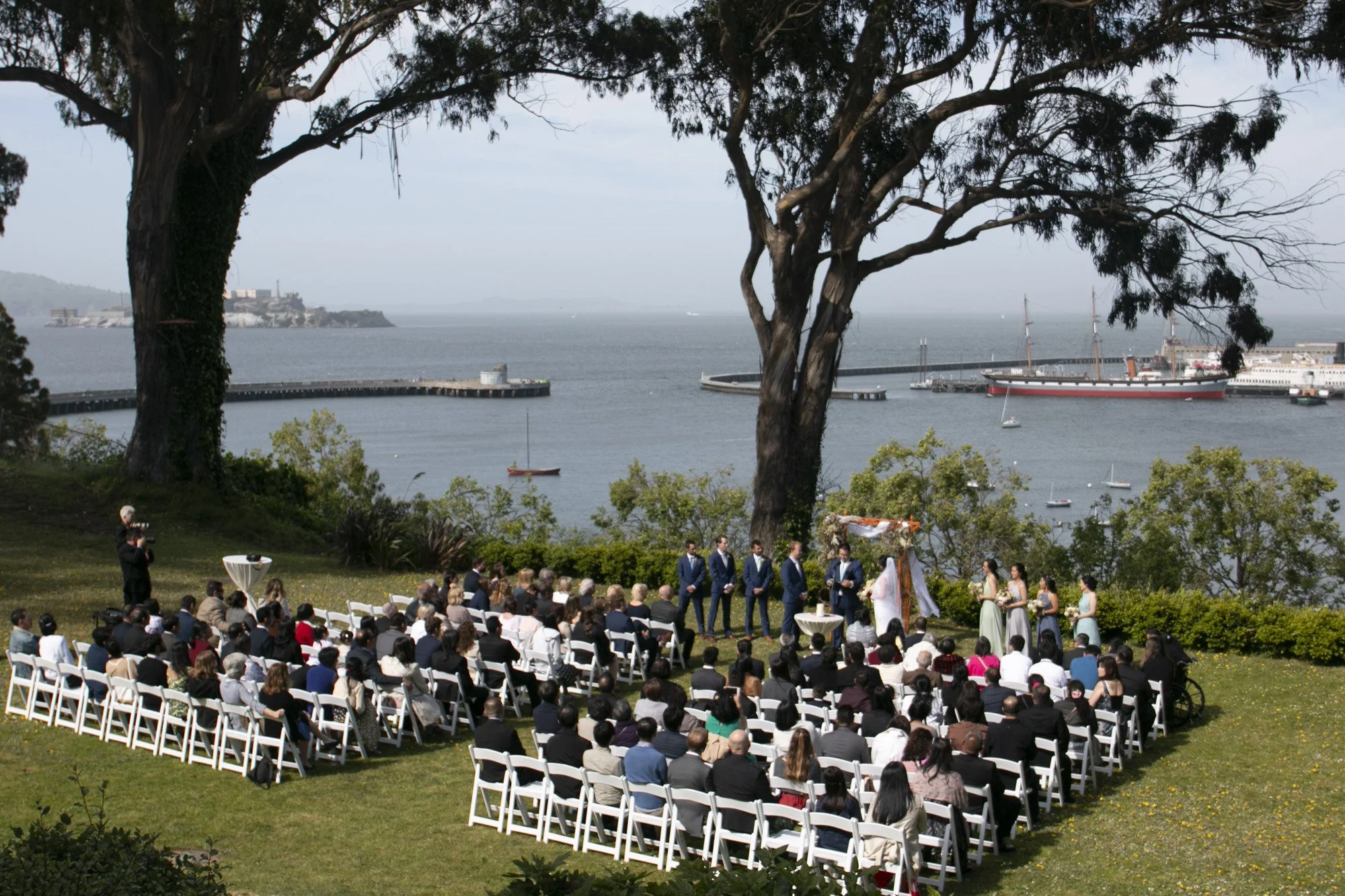 Guests seated at an outdoor wedding overlooking the California coast.