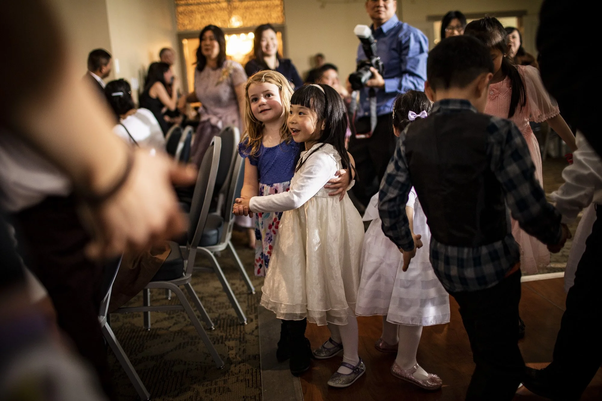 Young girls watching the dancing at a wedding reception.