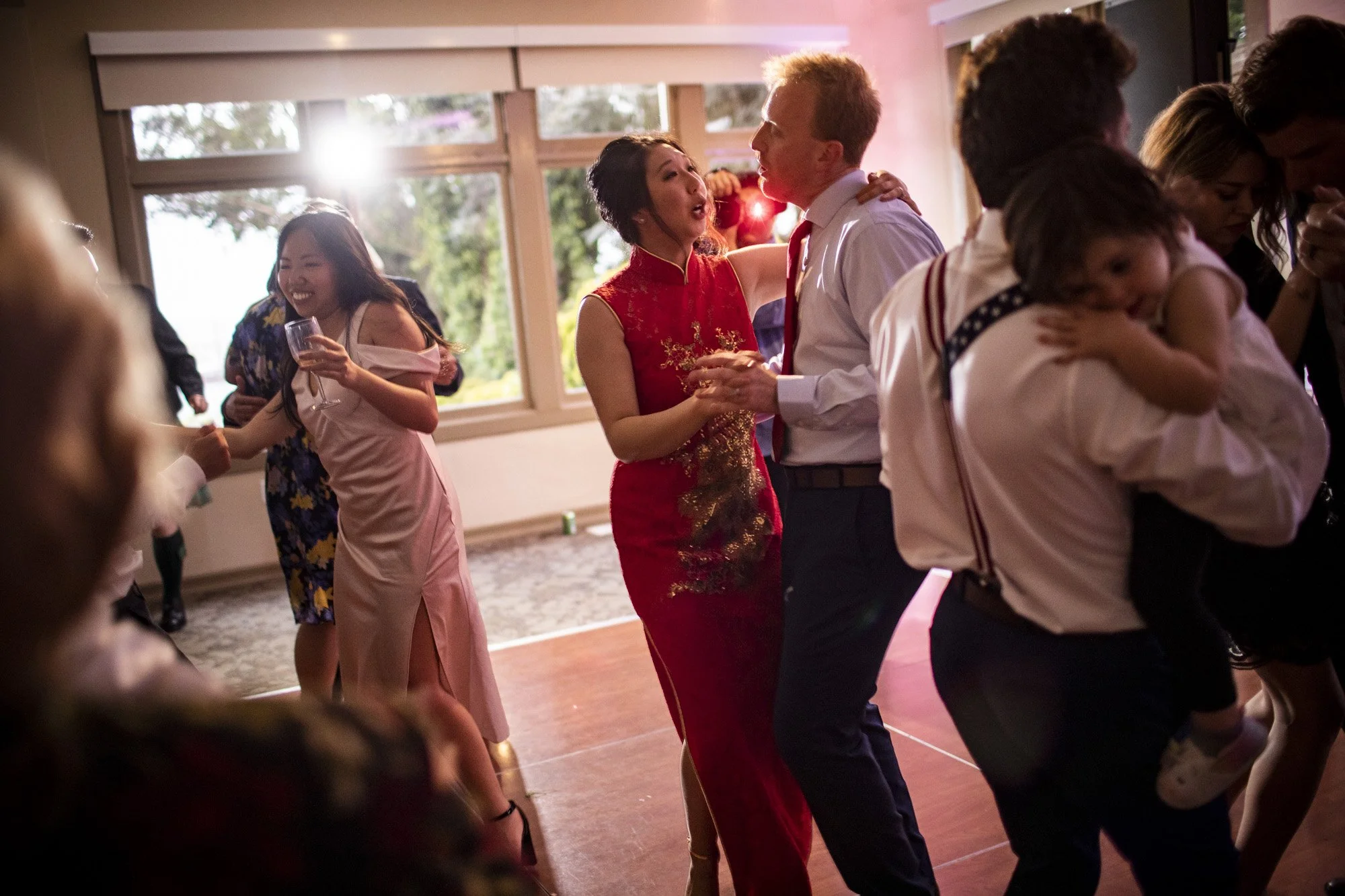 Bride and groom holding one another on the reception dance floor.