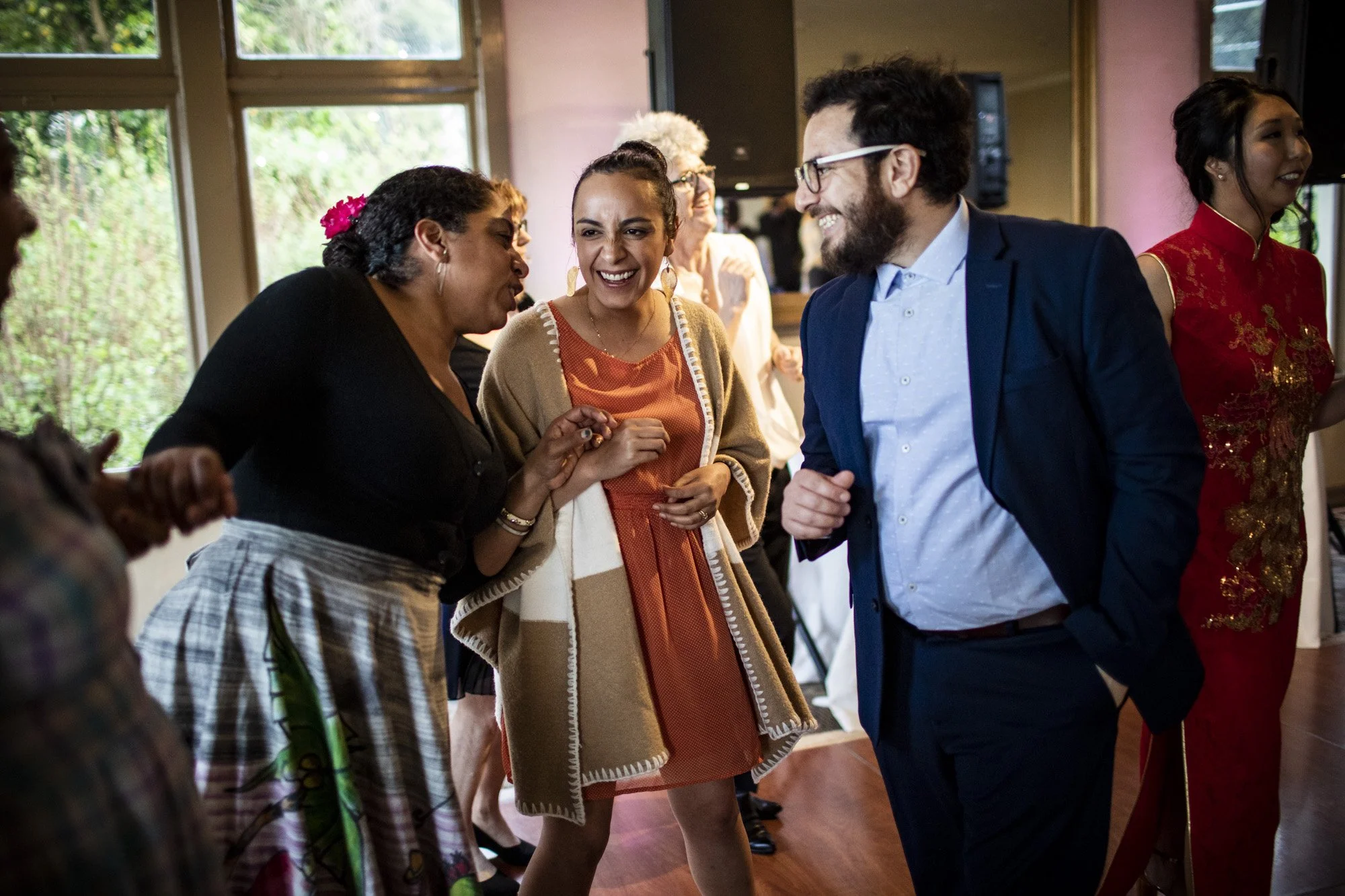 Friends laughing together during the wedding reception.