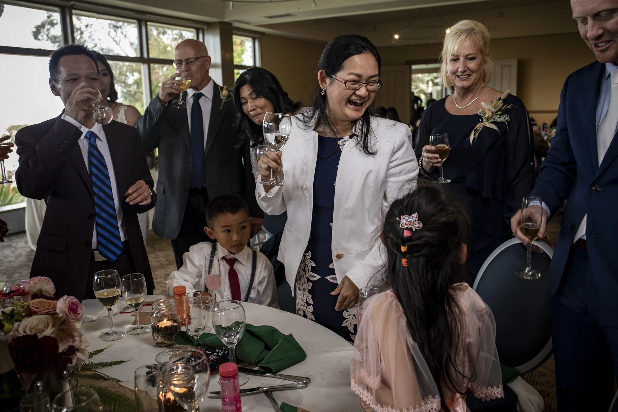 Toasting with family gathered around the reception table.