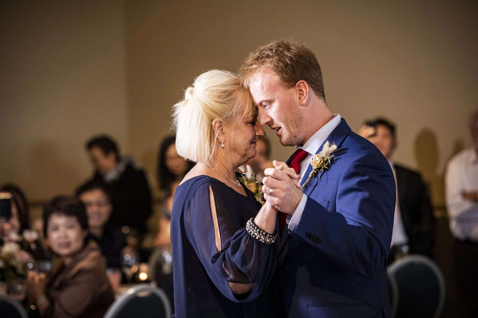 Groom dancing closely with his mother during the reception.