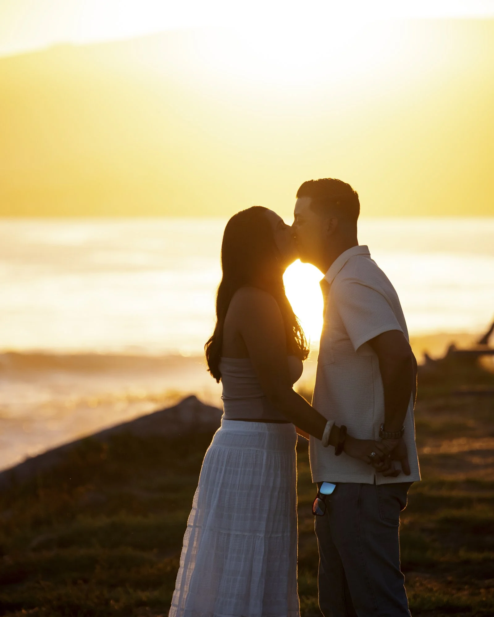 Couple sharing a quiet moment during their sunset proposal portraits on California’s Gaviota Coast.