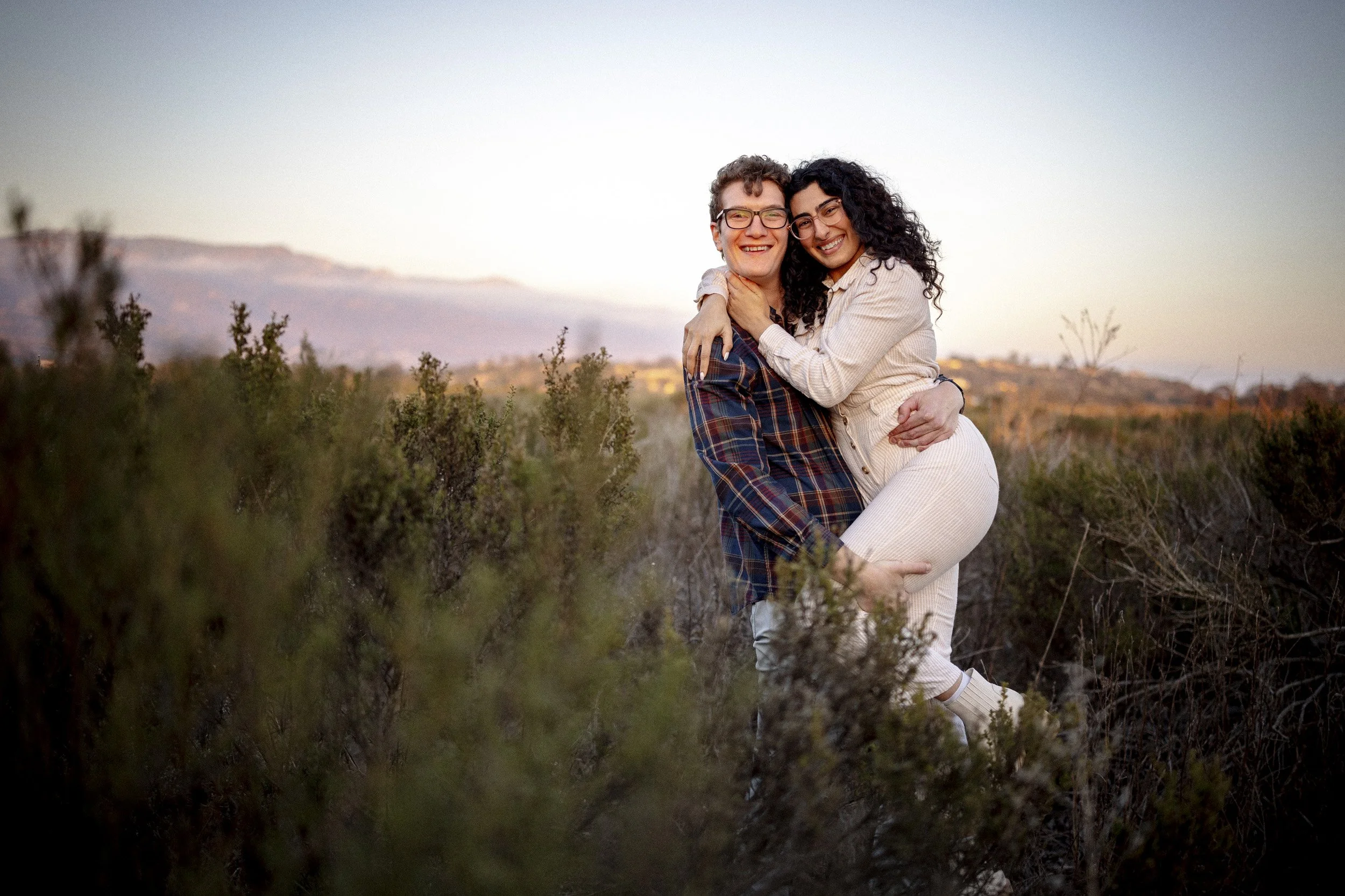 Smiling woman with her partner during a Santa Barbara engagement session.
