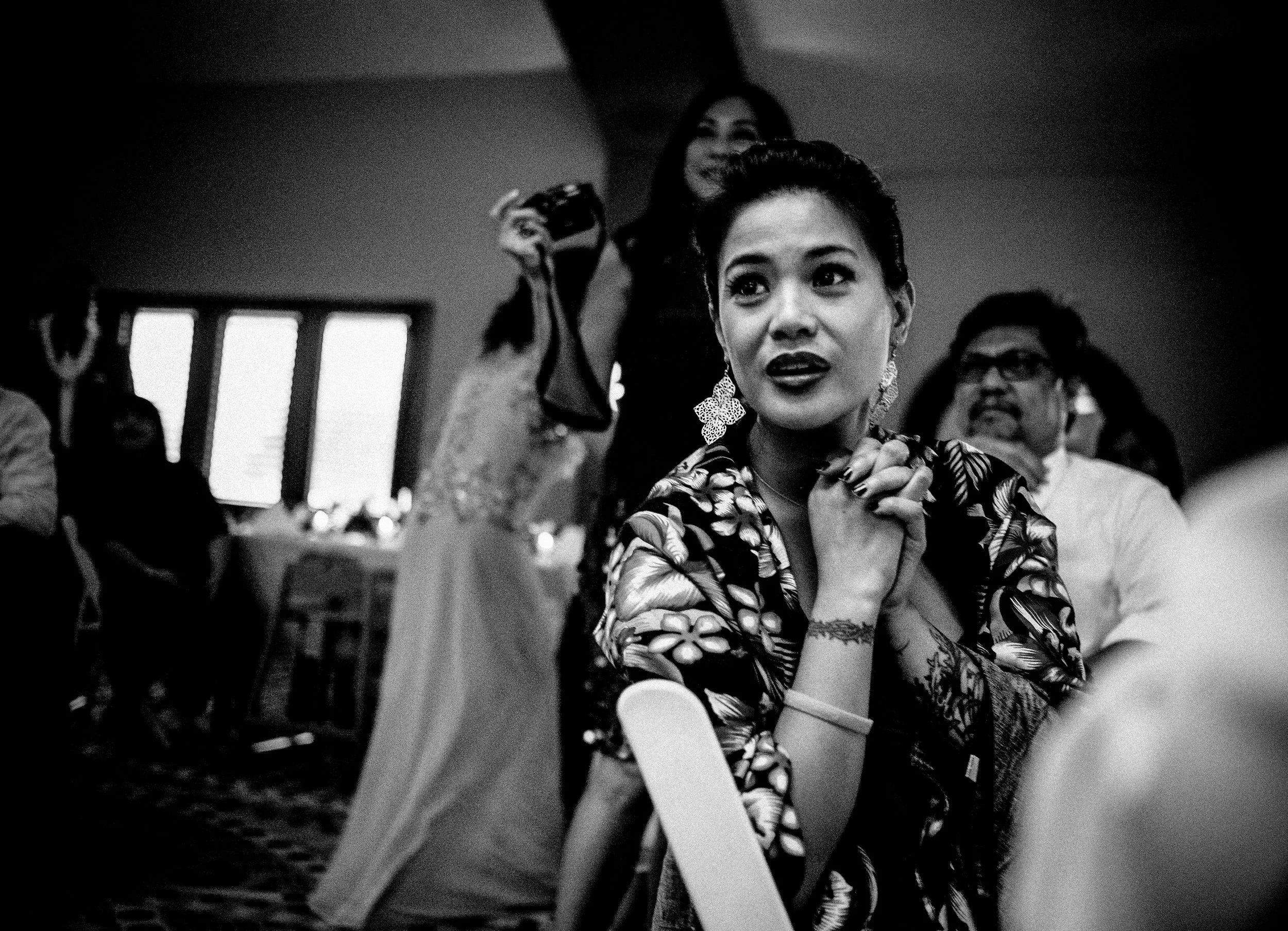 Wedding guest reacting emotionally during a reception in black and white.