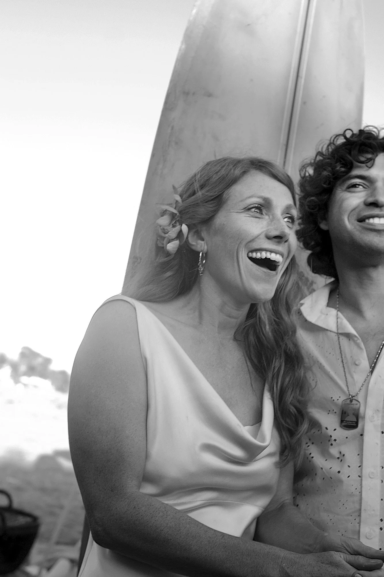 Couple laughing together during a wedding in black and white.