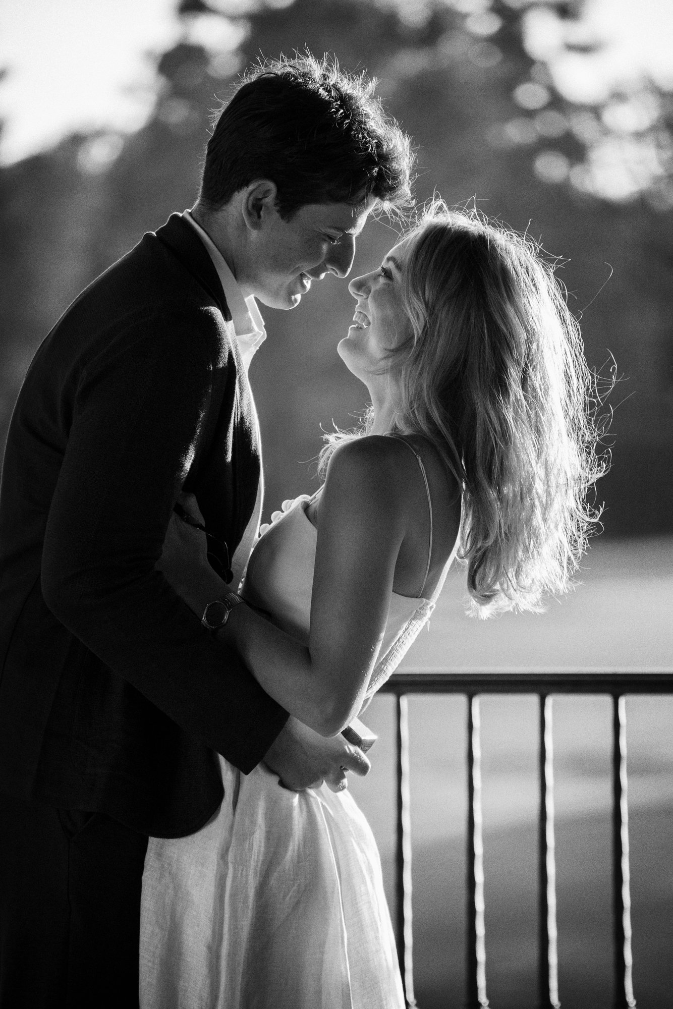 Newly engaged couple laughing together in a black-and-white portrait after their Wilshire Country Club proposal.