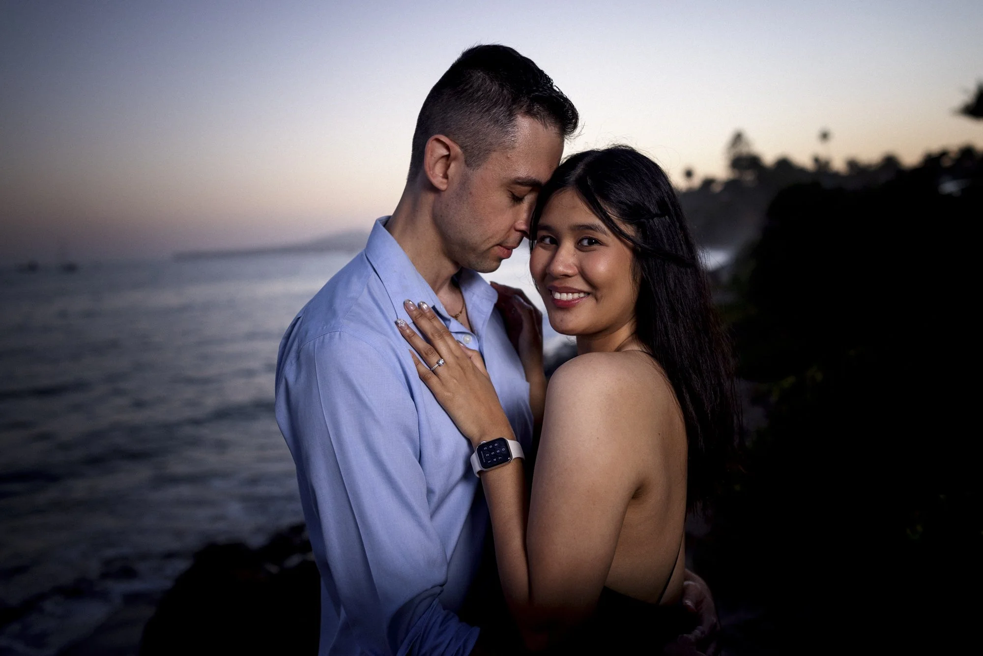 Smiling couple sunset surprise proposal in Montecito, California.