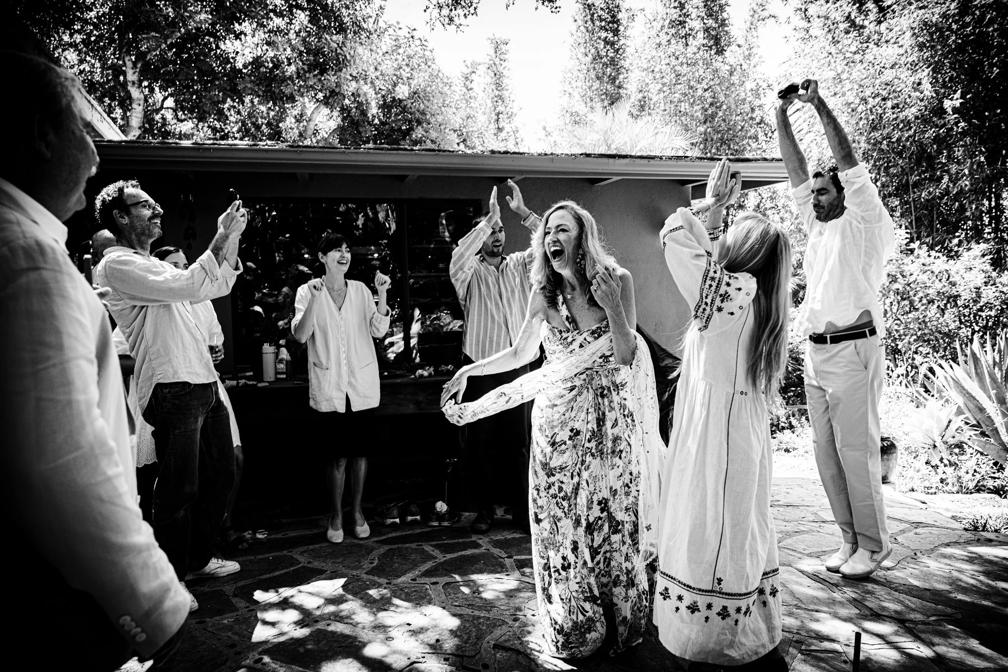 Family members laughing together after their planned birthday portraits in Montecito.