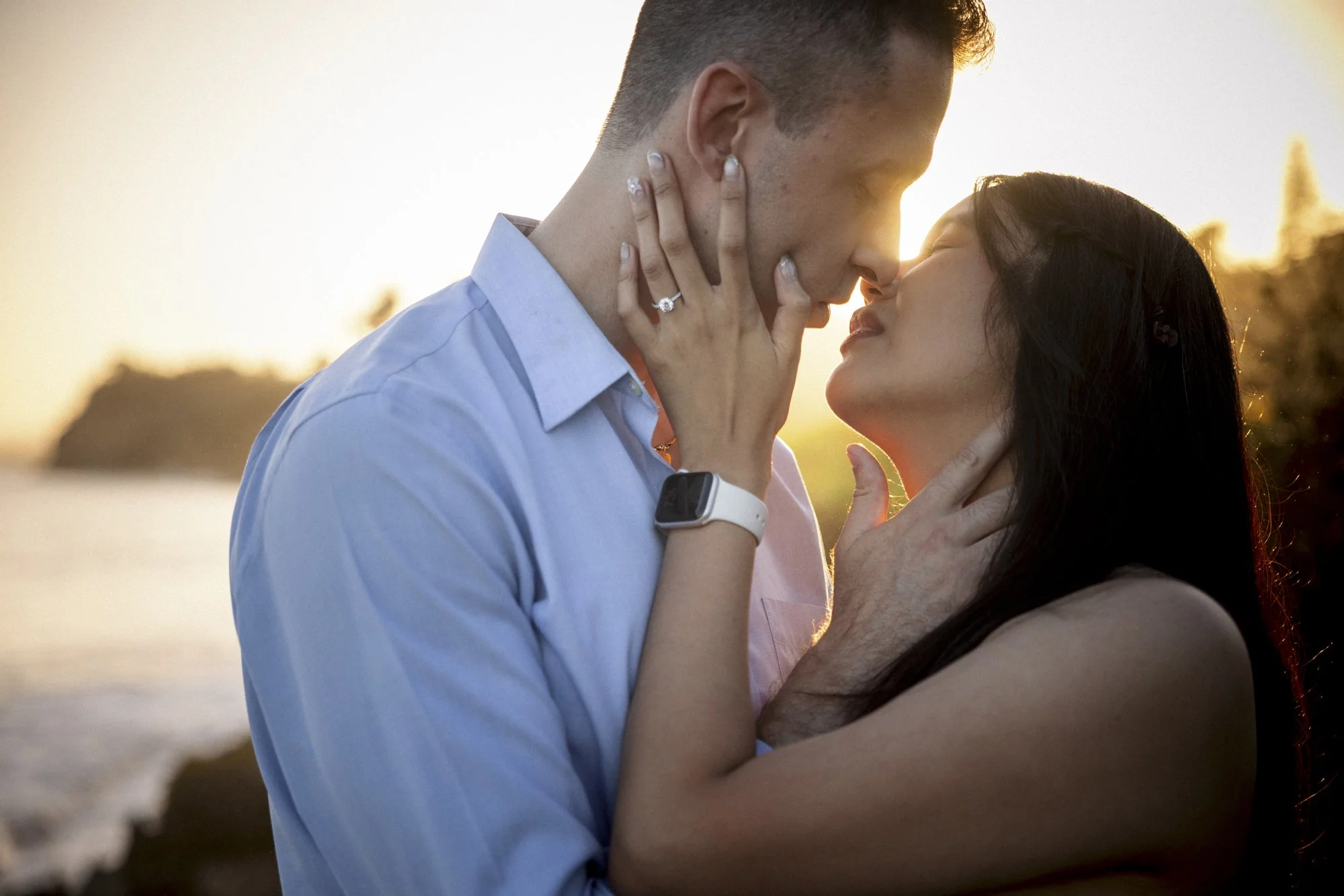 Newly engaged couple celebrating on Butterfly Beach after a surprise proposal in Santa Barbara County.