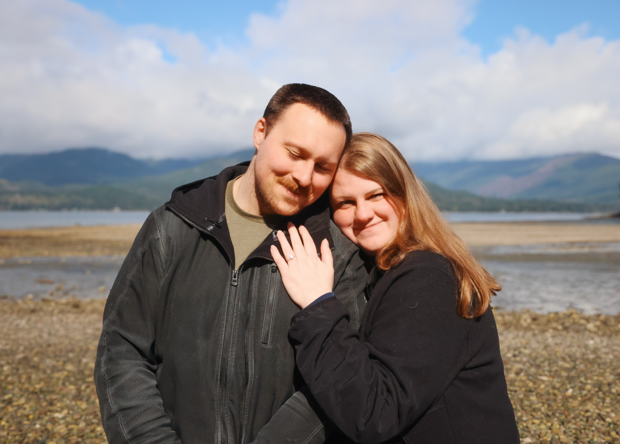 Engagement shoot on a rocky beach on a sunny day