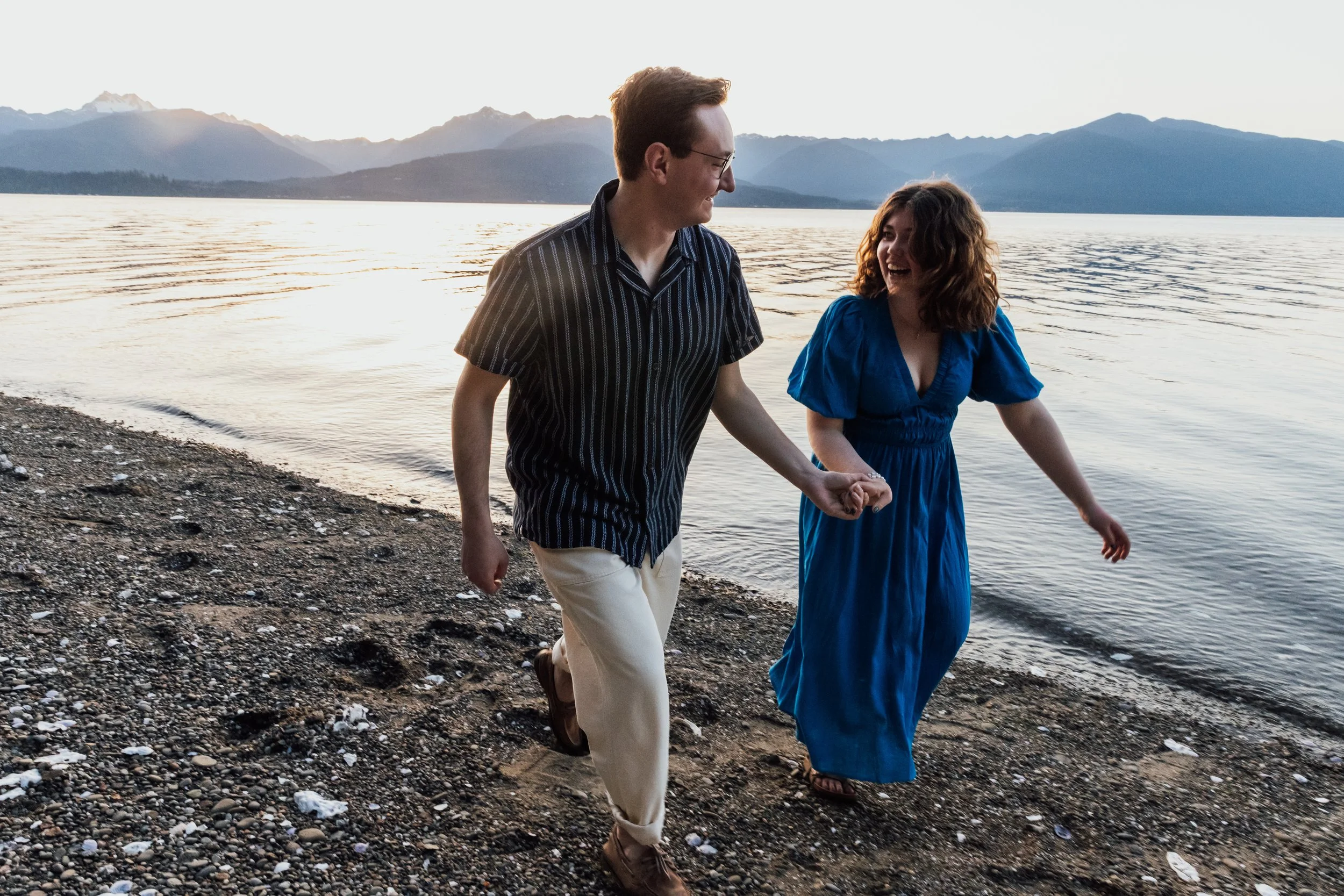 Engagement shoot of couple running on the beach
