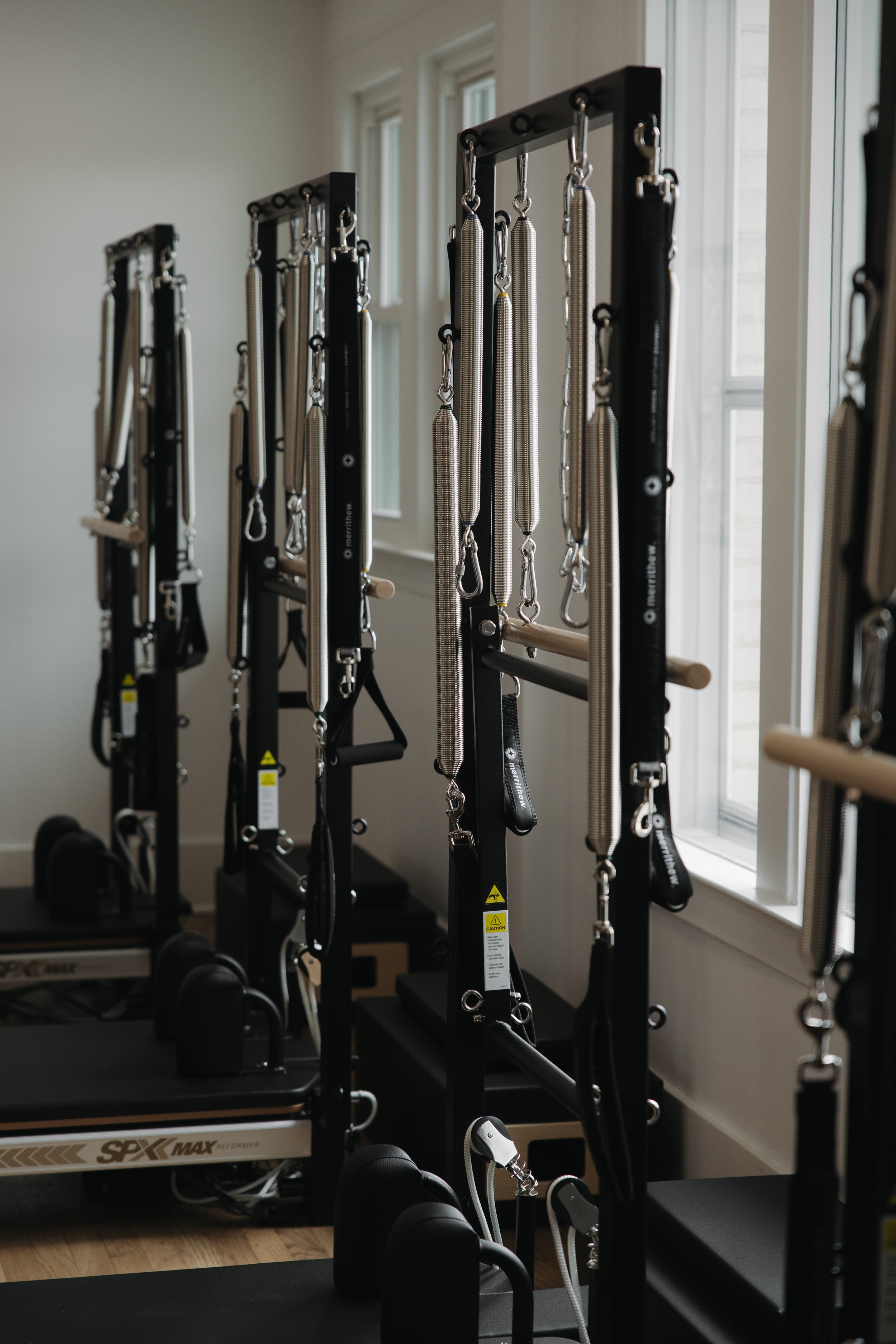 Pilates studio with professional Merrithew Reformers and Vertical Frame Towers.