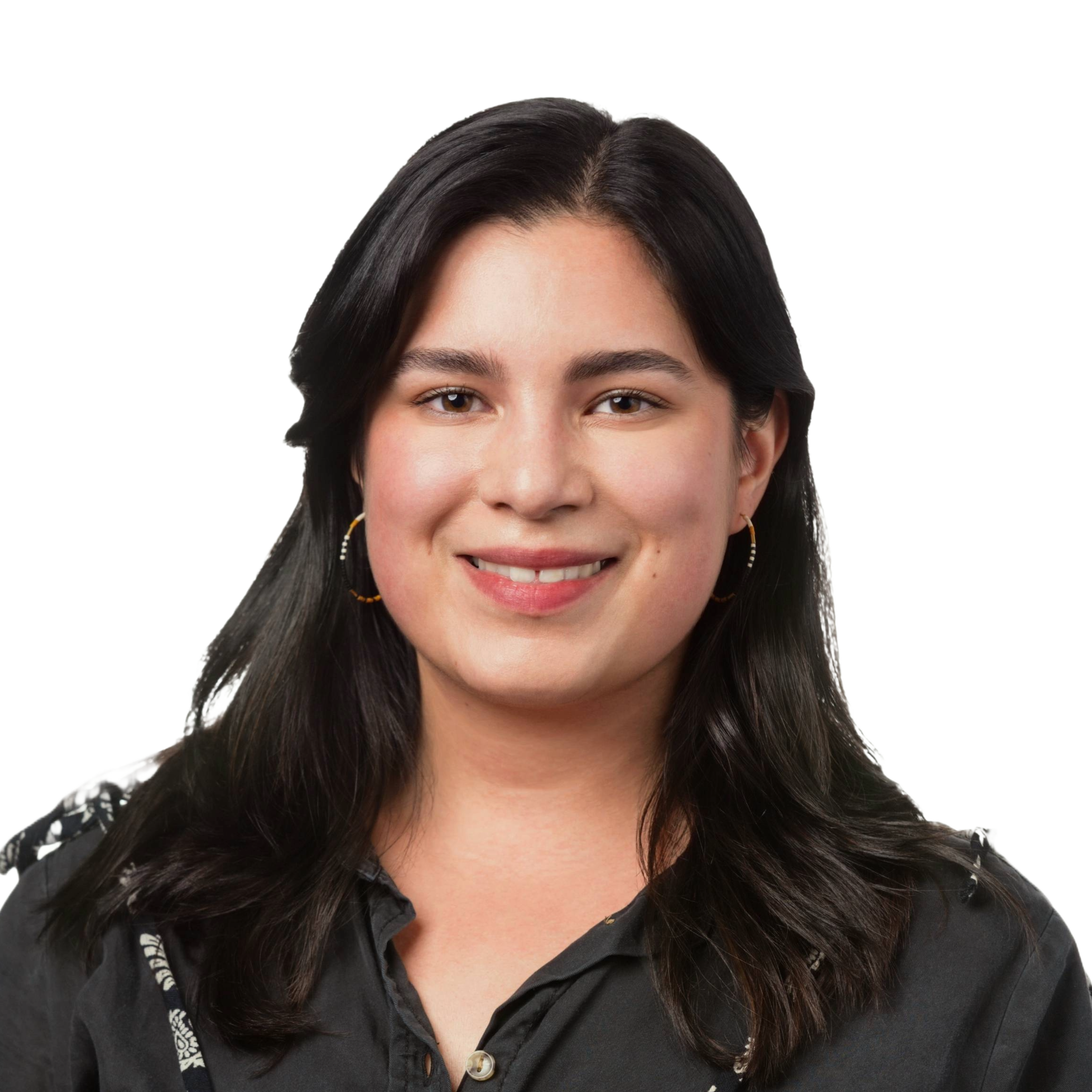 Dr. Anjur-Dietrich is smiling. She has shoulder length black hair and is wearing a black button down top.