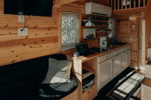Interior view of a wooden tiny home featuring modern, cozy design elements and efficient use of space.