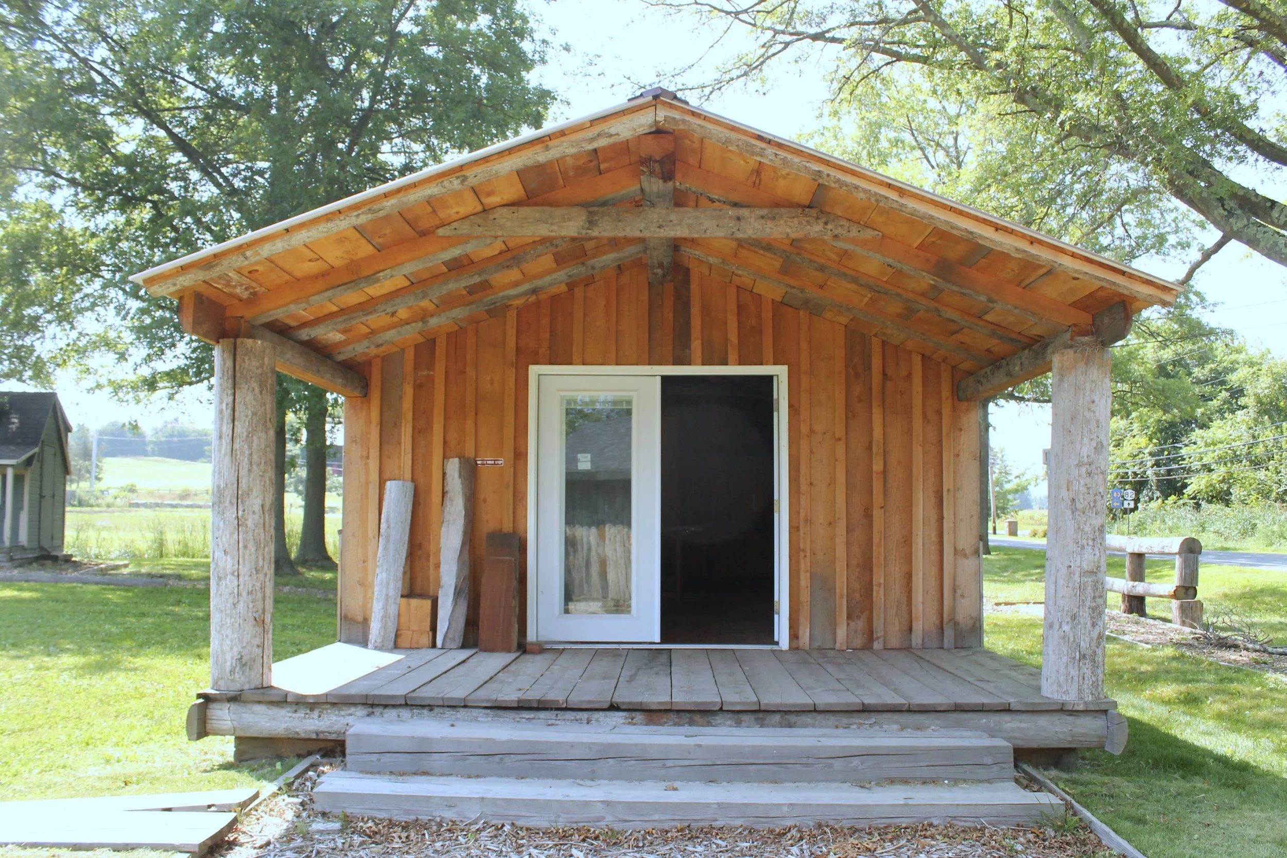 Charming exterior of a wooden tiny home with natural wood siding and a small front porch.