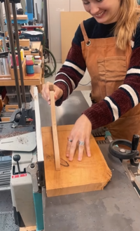 Woman learning woodworking techniques in a Swiss workshop
