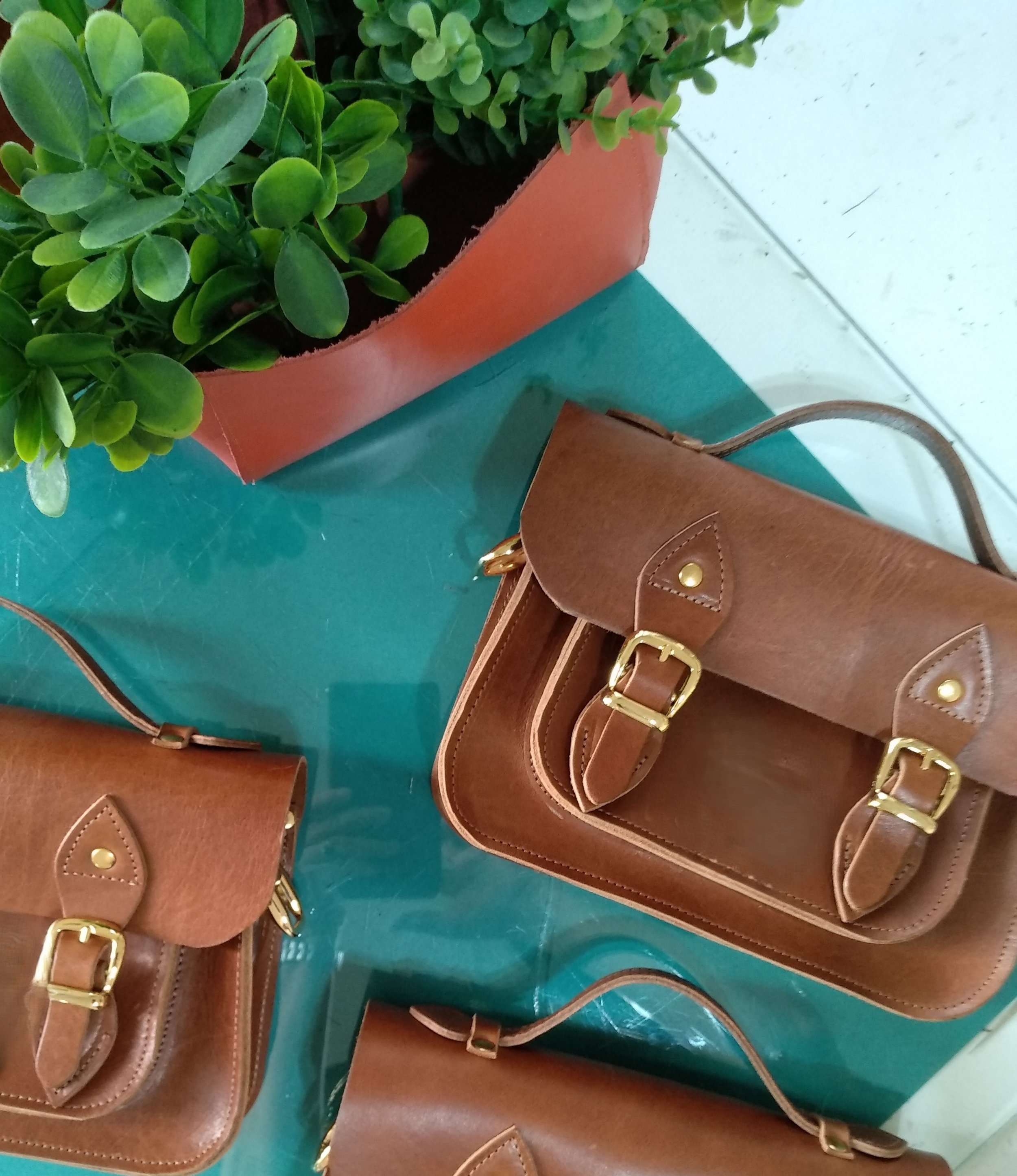 Finely crafted leather satchels made by participants during a Concentric Travel leatherworking workshop in Argentina.