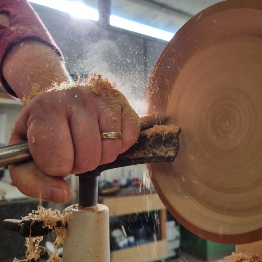 Close-up of woodturning on a lathe during a beginner workshop in Switzerland