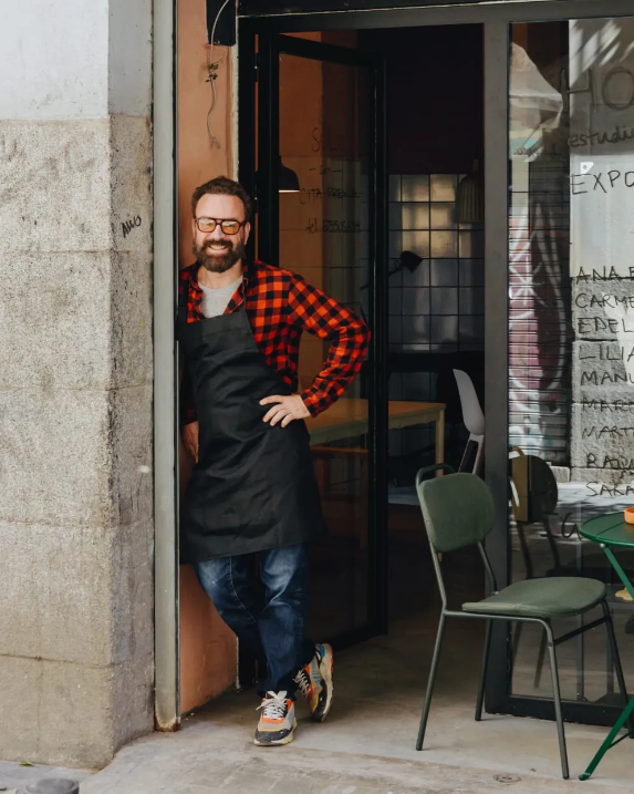 Ceramic artist standing in the doorway of his studio - connect with talented potters like him through Concentric Travel’s immersive workshops.