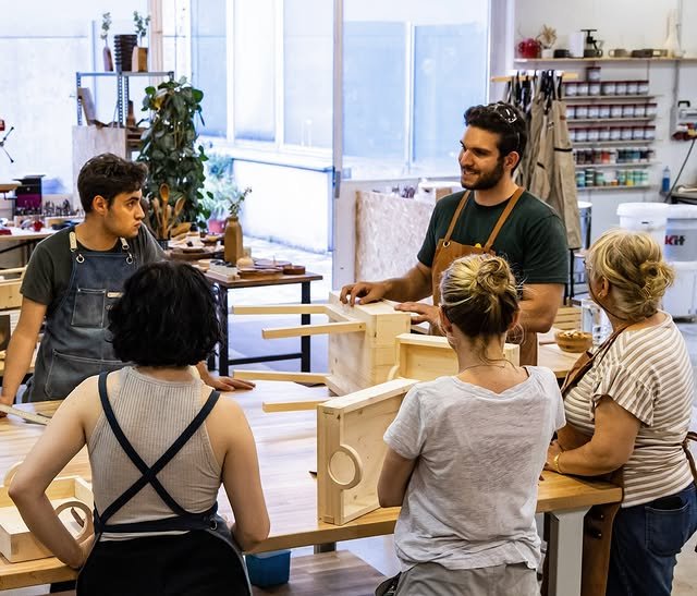 Students learning woodworking in a Swiss workshop during a beginner class