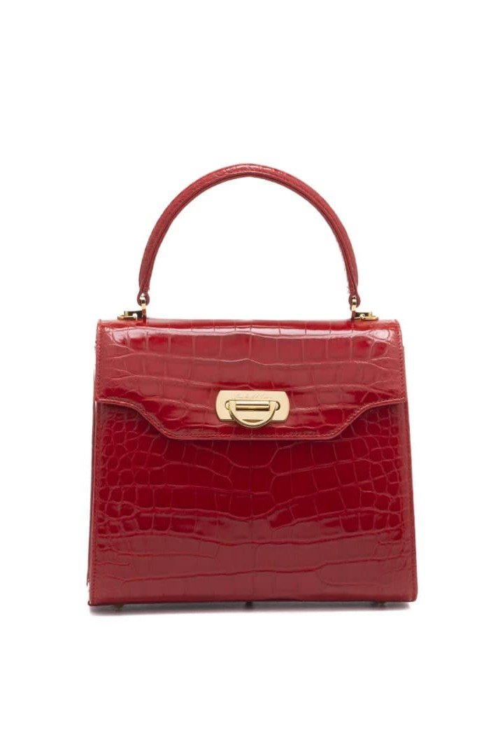 Red crocodile-embossed leather handbag with a gold clasp and handle, isolated on a white background.