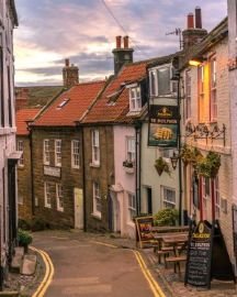 Street in a British town with historic brick buildings and traditional storefronts