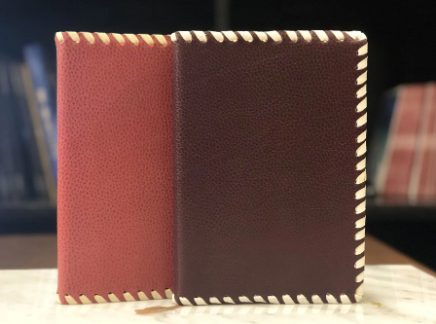 Custom leather book cover crafted during a workshop in Florence, Italy, showcasing fine craftsmanship and elegant design.