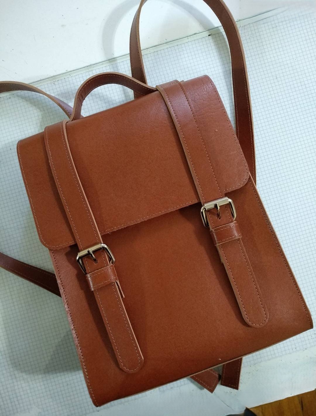 Brown leather backpack crafted in the choose-your-own-project leather workshop in Buenos Aires with Concentric Travel.