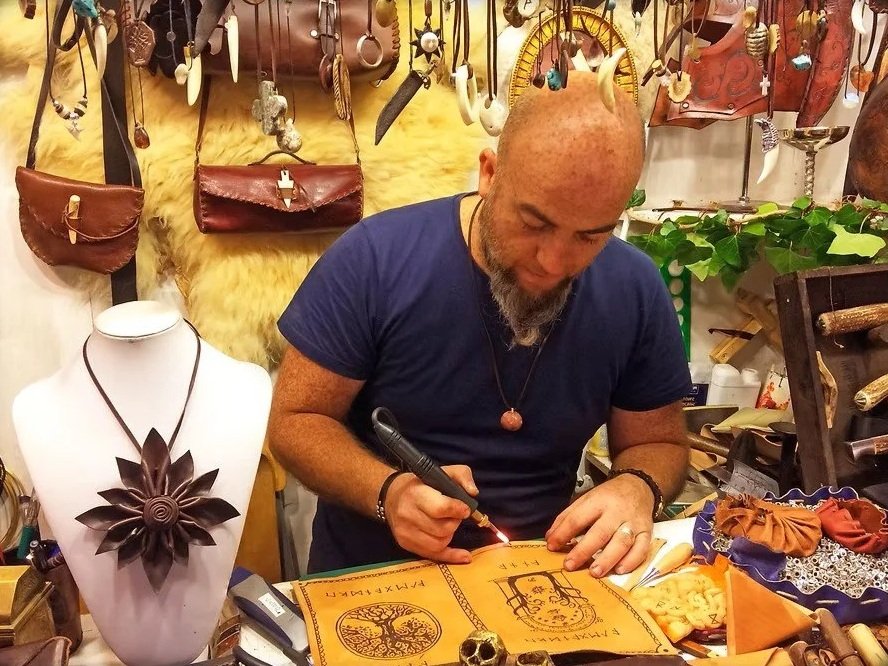 Barcelona leather artisan handcrafting custom leather goods in workshop