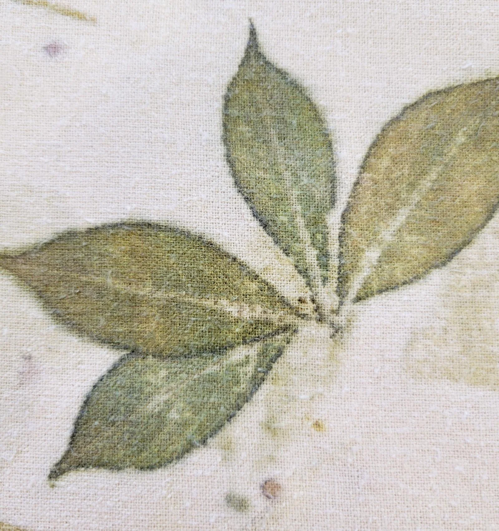 Detail of table runner with leaves and orange spots