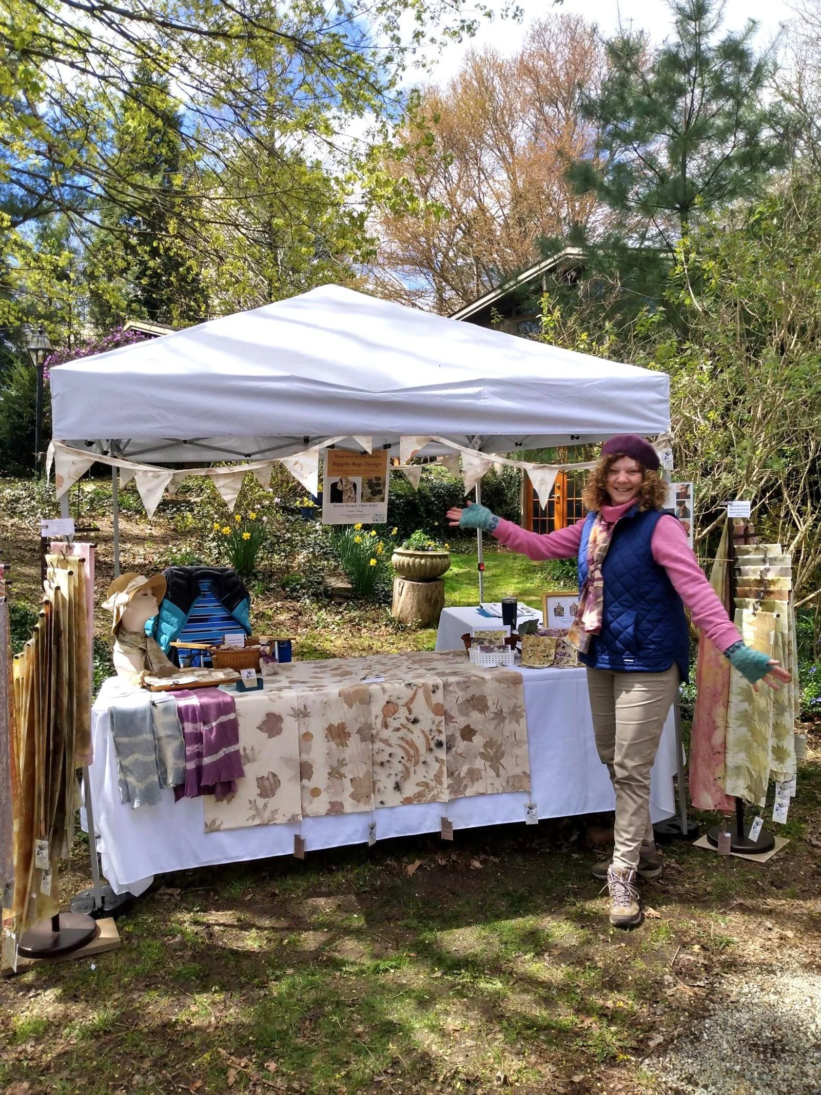 Robyn Borges standing in front of a tent with her artwork on display