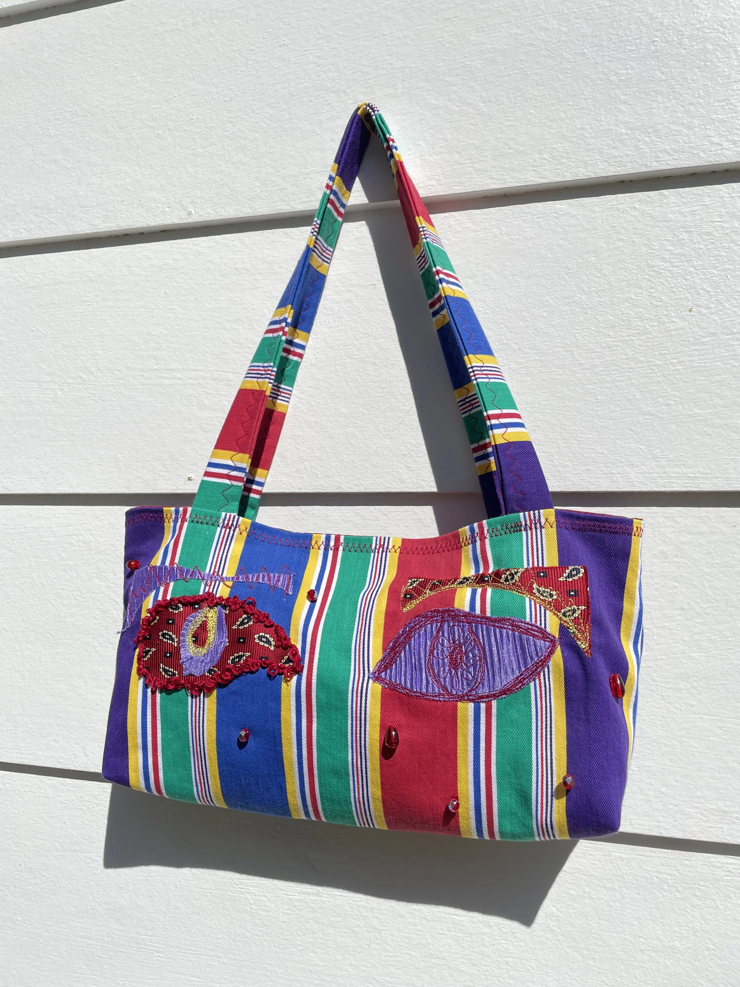 2024. Second hand cotton fabric, beads, red embroidery thread.