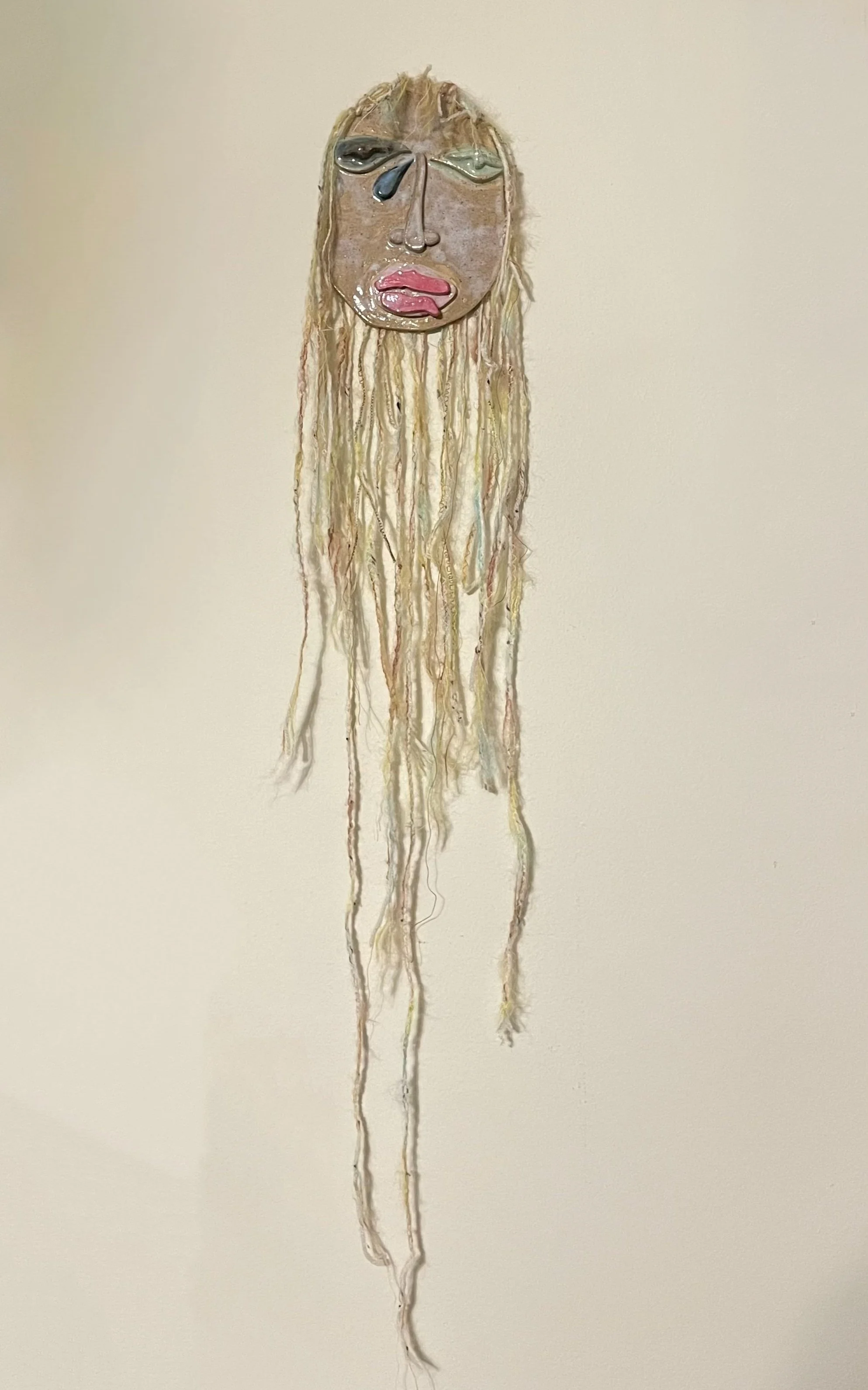 'She's The Kind of Girl', 2024.  Glazed ceramic, yarn, mohair. 42 x 6 in.