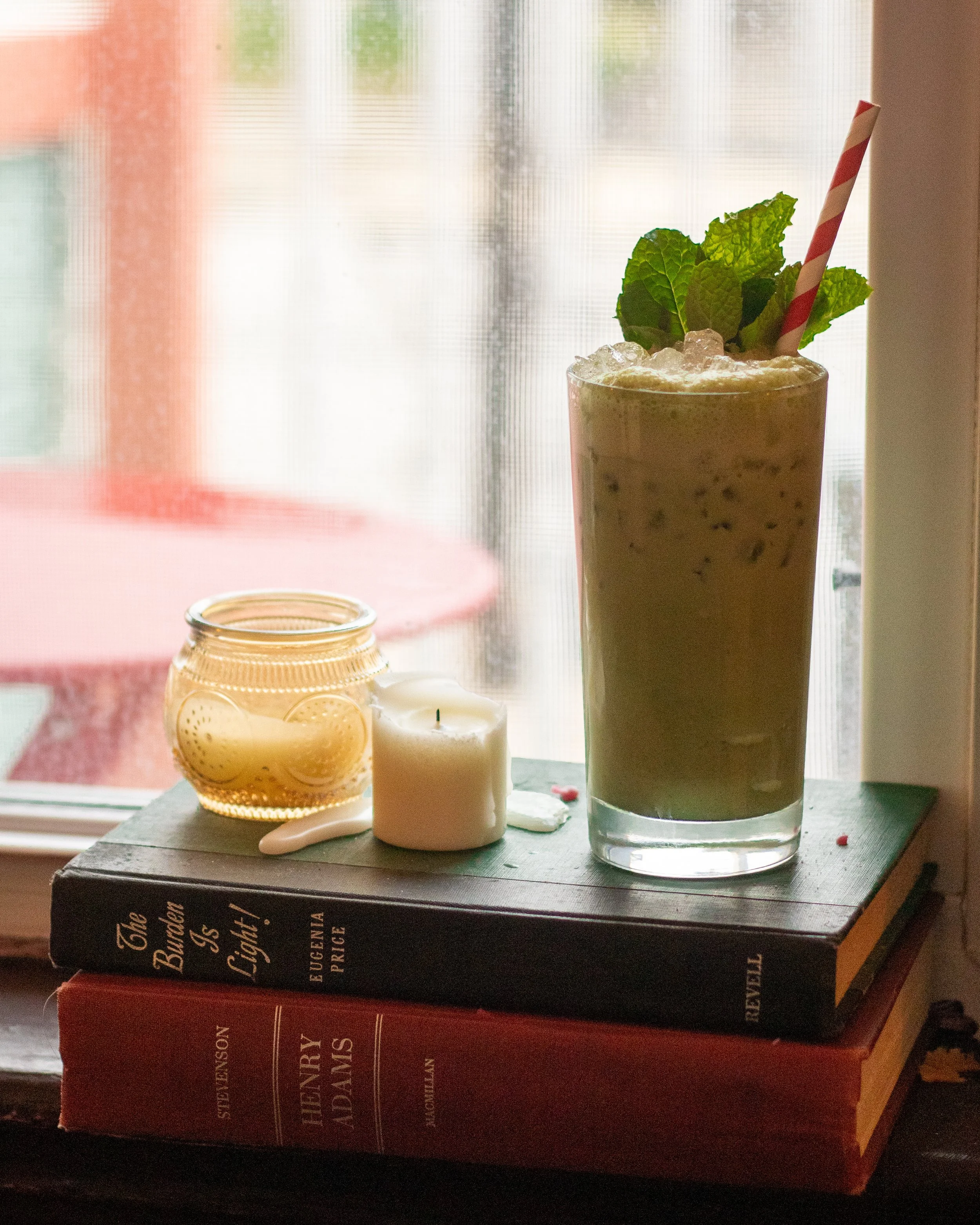 Styled specialty matcha latte with a mint sprig at Verna café in Midtown Nashville