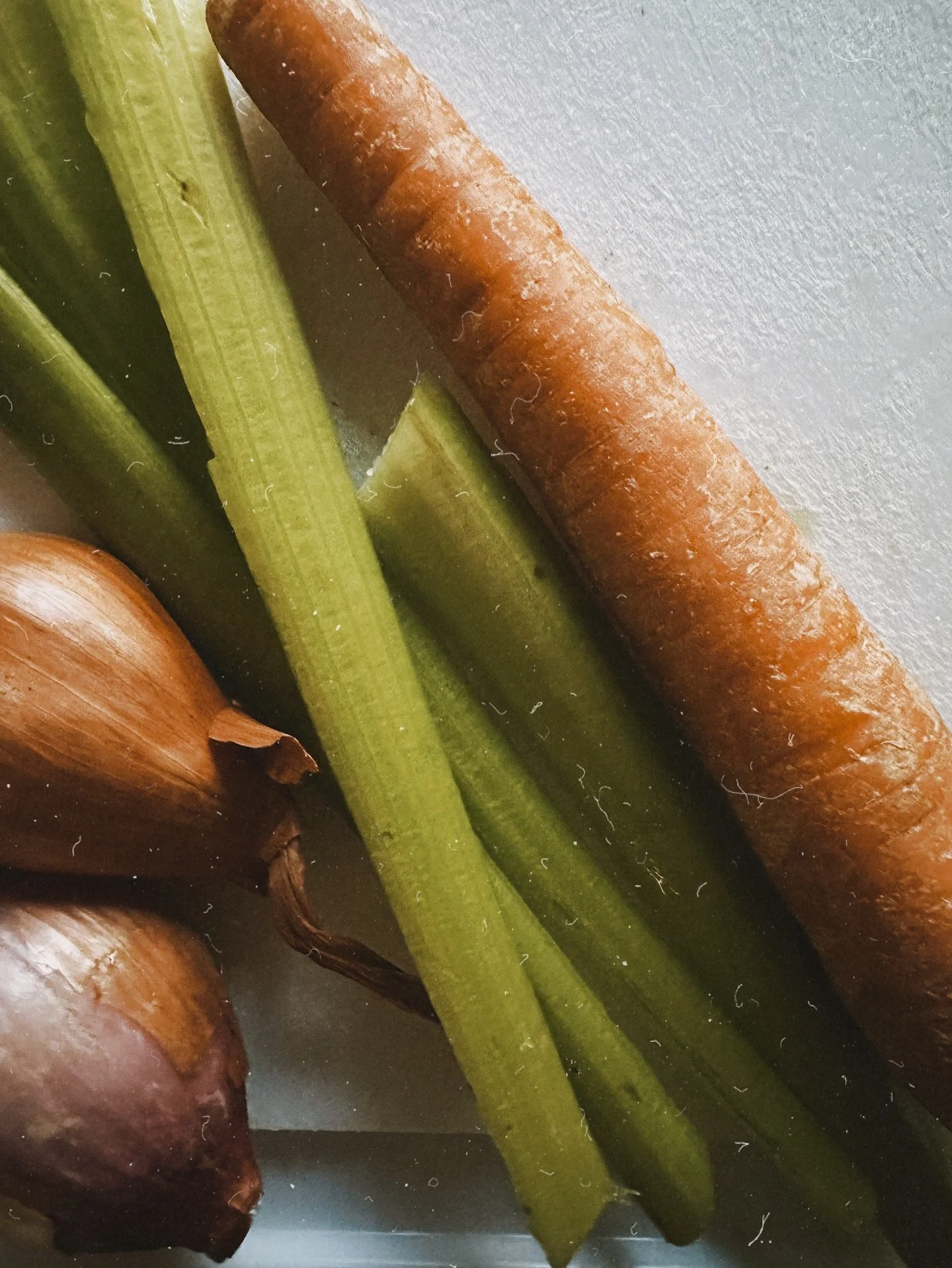 Early morning. Hot coffee, a little Billy Joel, celery, carrots, &amp; shallots ready to be made into soup. Stinky bulldog at my feet. 
Finding joy, creating cozy &amp; brightening my day in the month they call &lsquo;the gloomiest.&rsquo;