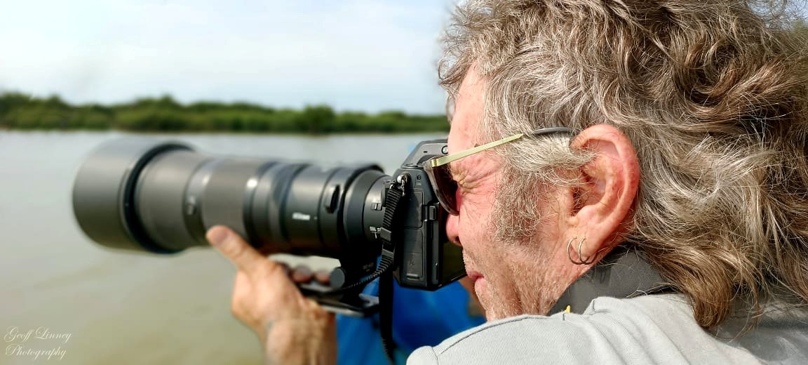 Geoffrey shooting from boat. Pearaing Cons Ctr