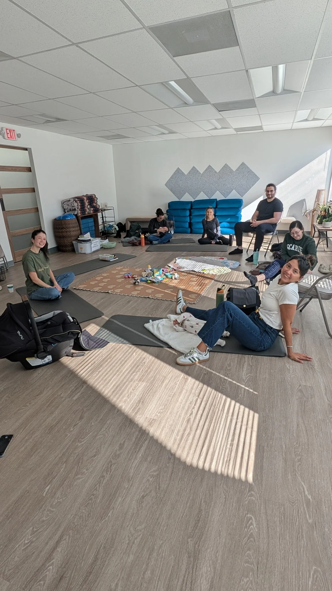 Parents sitting in circle with their babies on the floor.