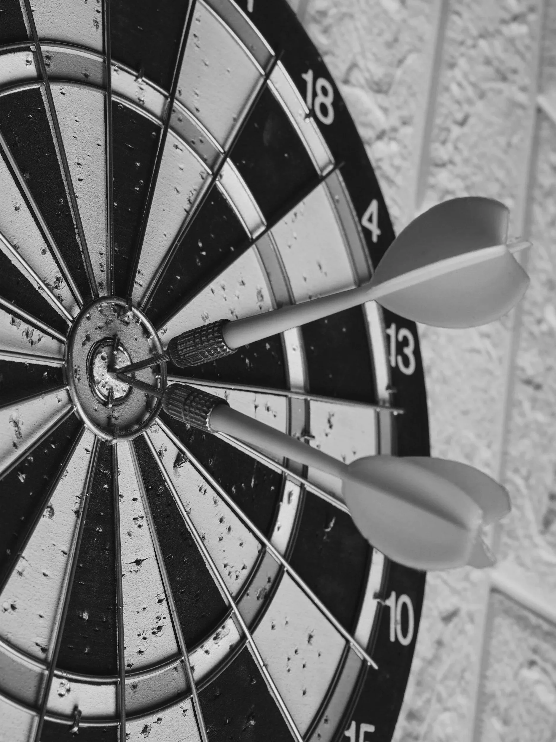 Close-up of a dartboard with a dart stuck in the bullseye.
