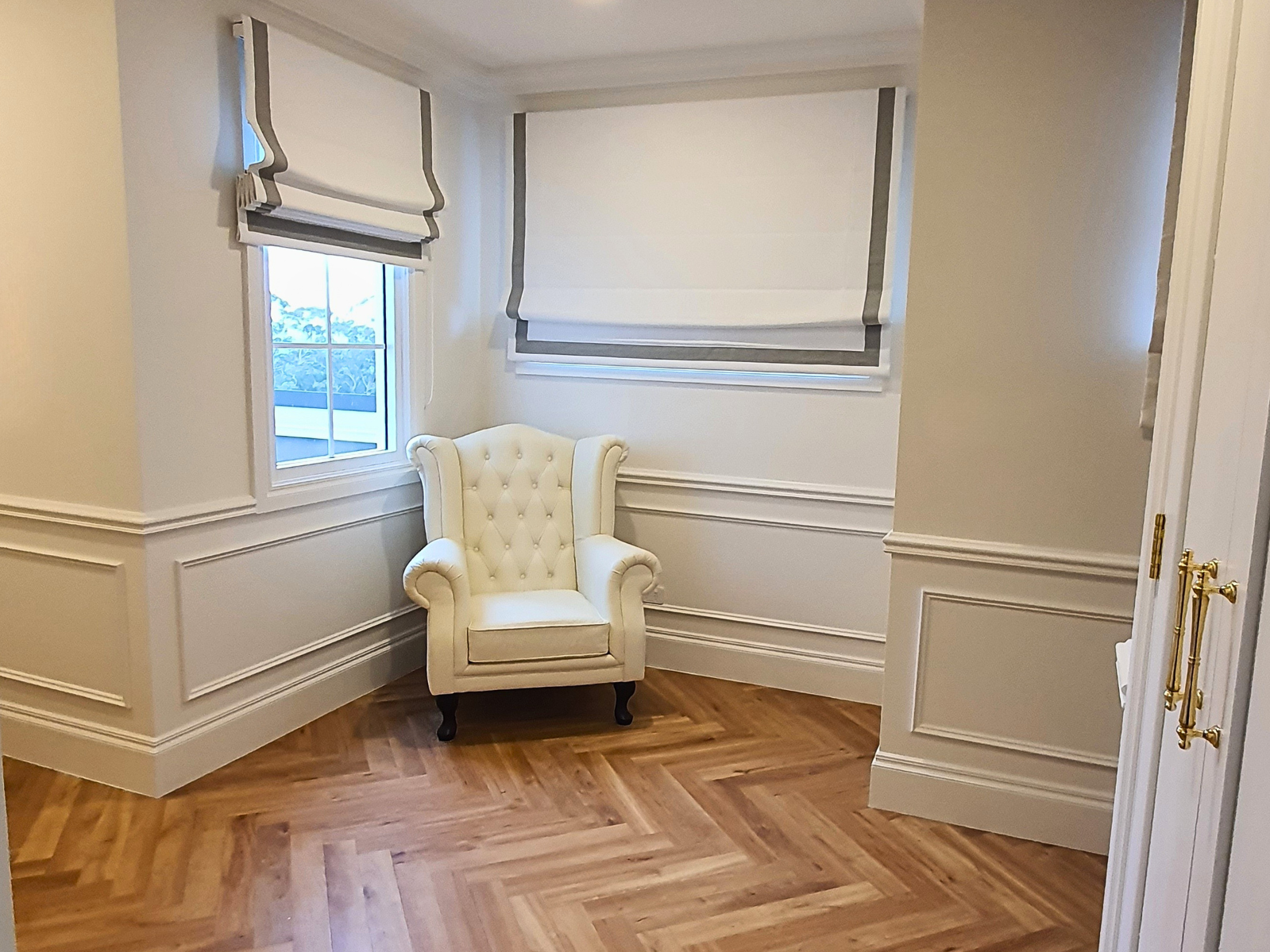 Beyond Walls - Luxurious armchair in hallway with half wall wainscoting in a house in Wollongong
