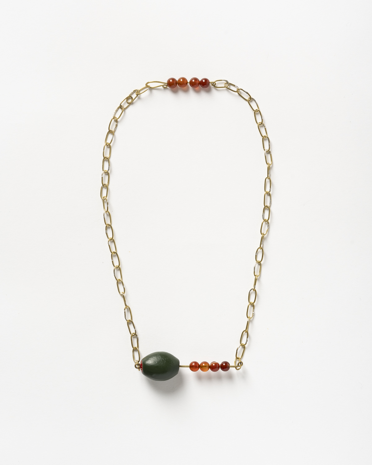 Necklace titled 'Get Stuffed; Have you seen the price of food?' (2025), made from brass, copper, garnet, enamel paint by Eleni Linou