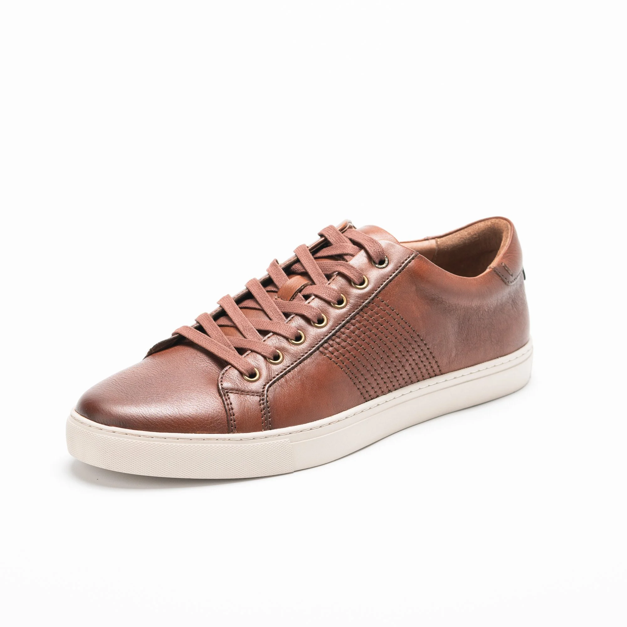 A single pinkish-brown leather sneaker with laces and white sole, partially visible on a white background.