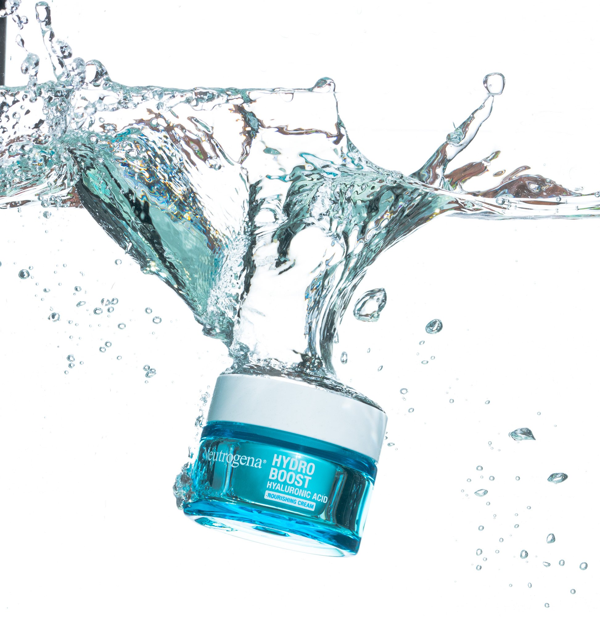 A glass of water with splash effects and a label on the front that reads 'Neutrogena Hydro Boost Hyaluronic Acid Nourishing Cream.'