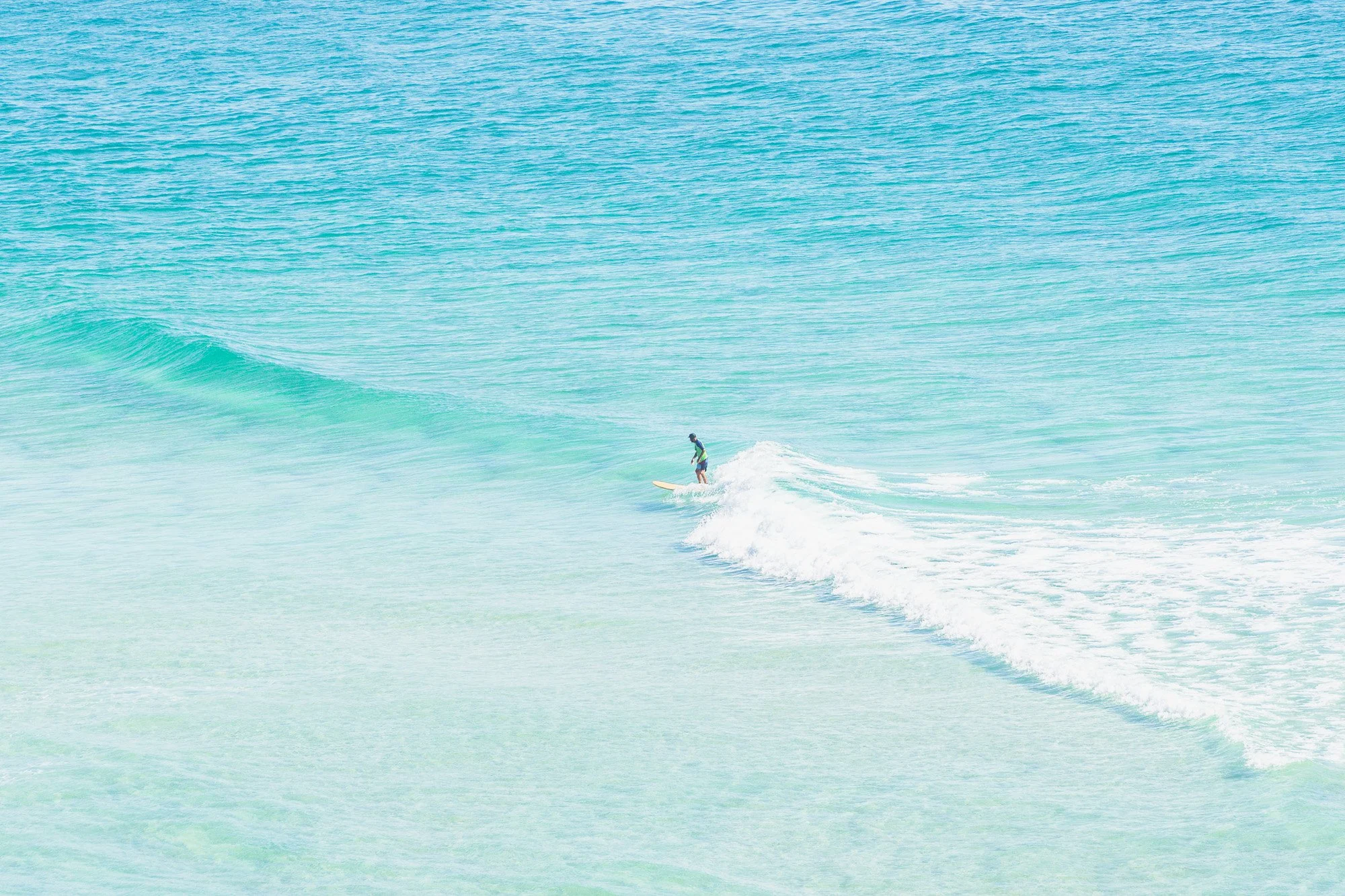A person surfing on a wave in the ocean