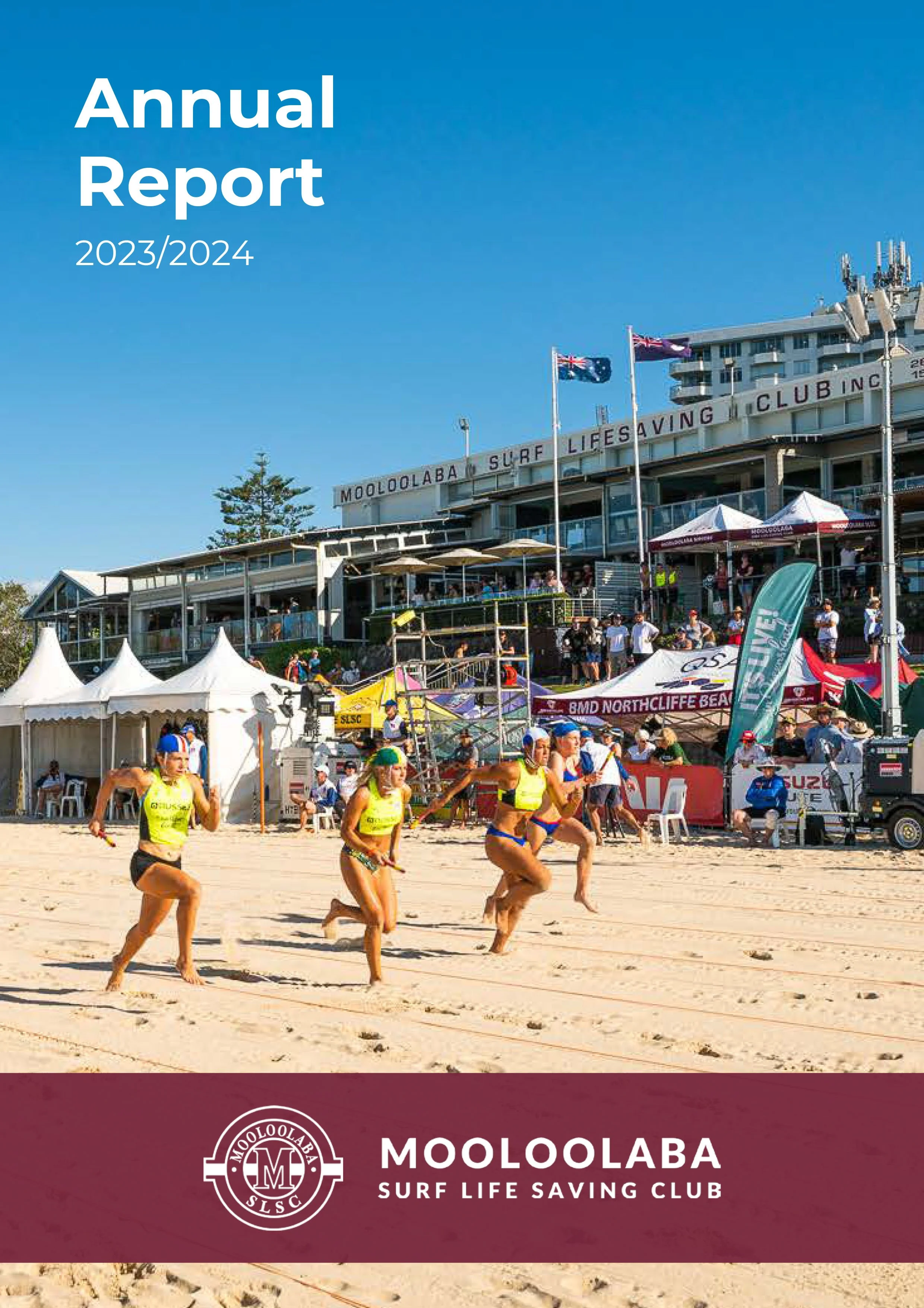 Beach scene with runners participating in a surf lifesaving club event, tents, and a building with flags in the background at Mooloolaba Surf Life Saving Club.