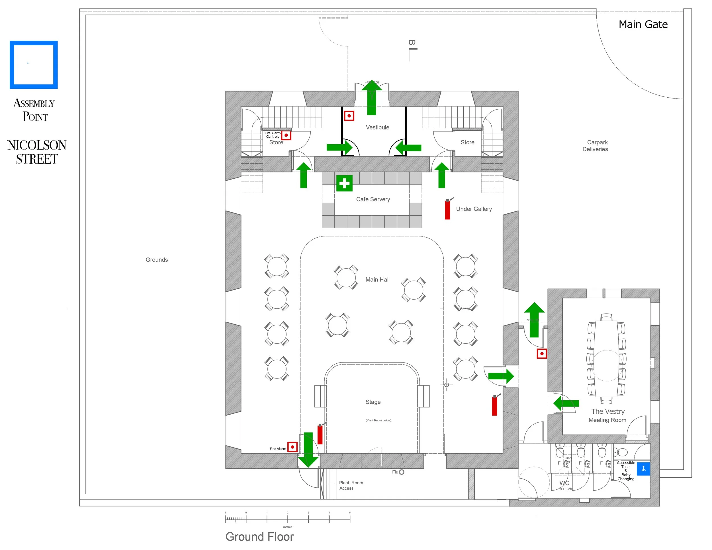 Floor plan of The Makers' Kirk, Greenock - ground floor showing various rooms and features, including a stage, main hall and ,toilets. Green arrows indicate entrances and exits, while red symbols mark fire alarms.