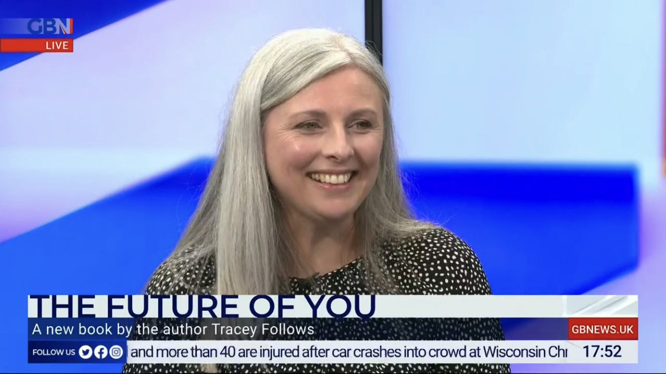 A woman with long silver hair who is Tracey Follows the Futurist is smiling during a live television interview on GB News, caption says The Future of You 