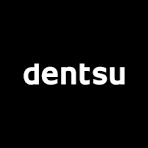Close-up of a black Dentsu logo with white lowercase letters