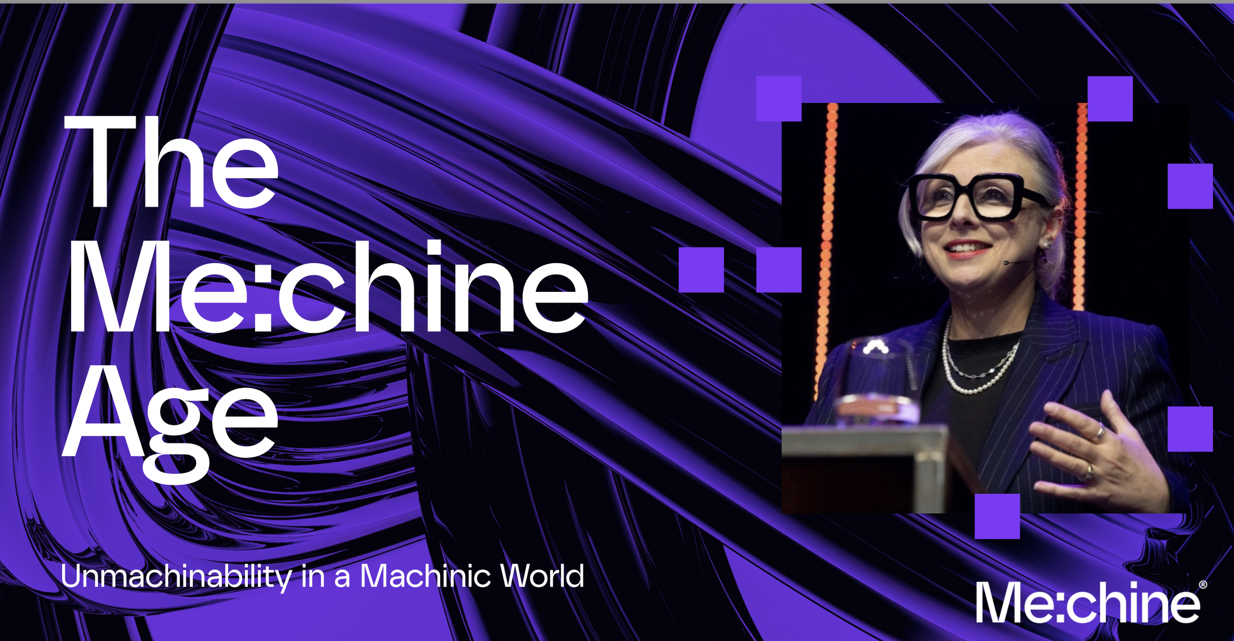 A woman with gray hair, glasses, and a black pinstripe blazer speaking at a conference or event, with a microphone headset, behind a presentation slide with a purple swirling abstract background and the text 'The Machine Age: Unmachinability in a Mac